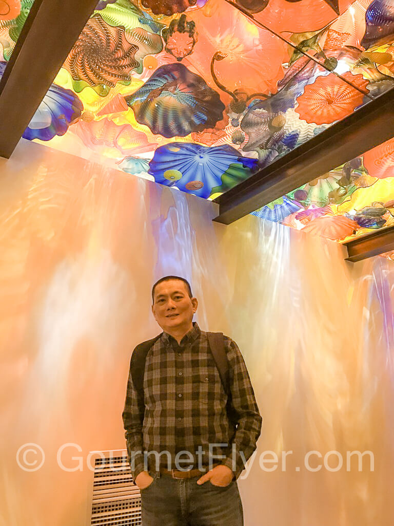 The Gourmet Flyer posing at Chihuly Garden and Glass in Seattle - a great thing to do