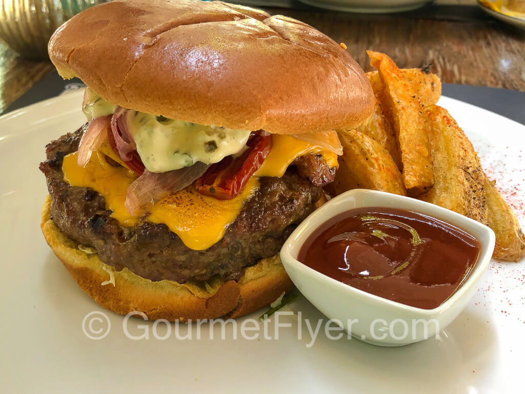 Bacon cheeseburger served with fried.