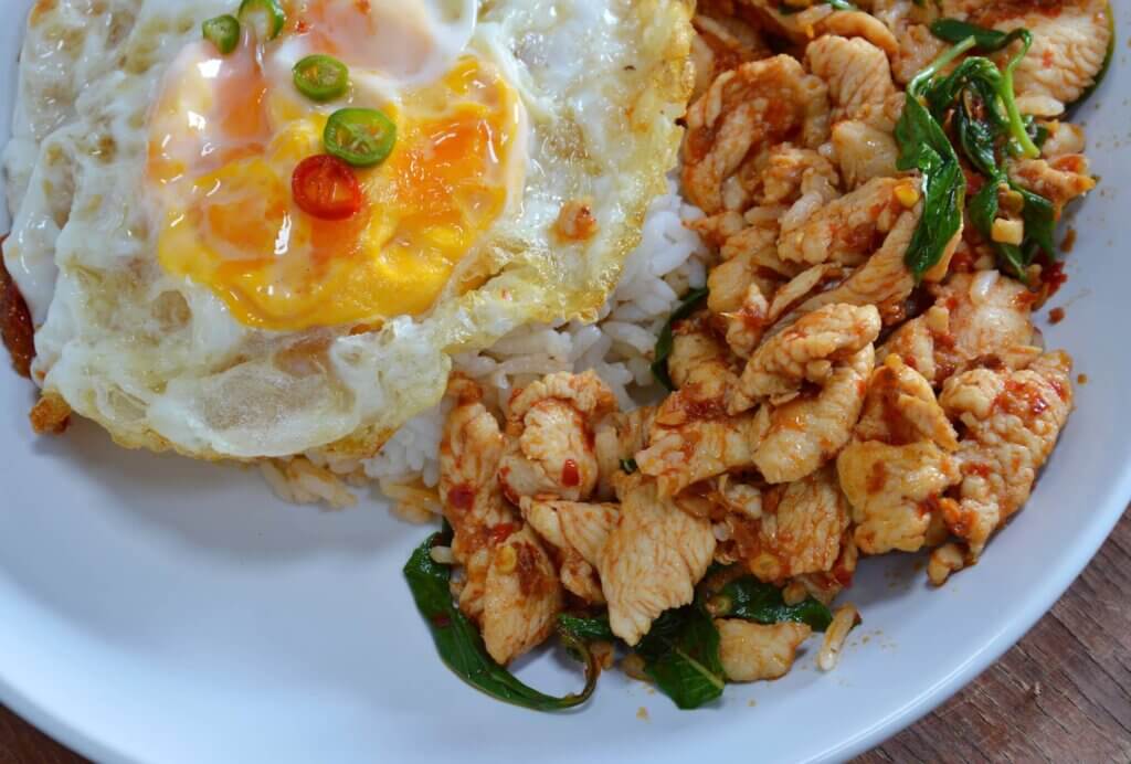 A dish with meat and rice, topped with a fried egg.