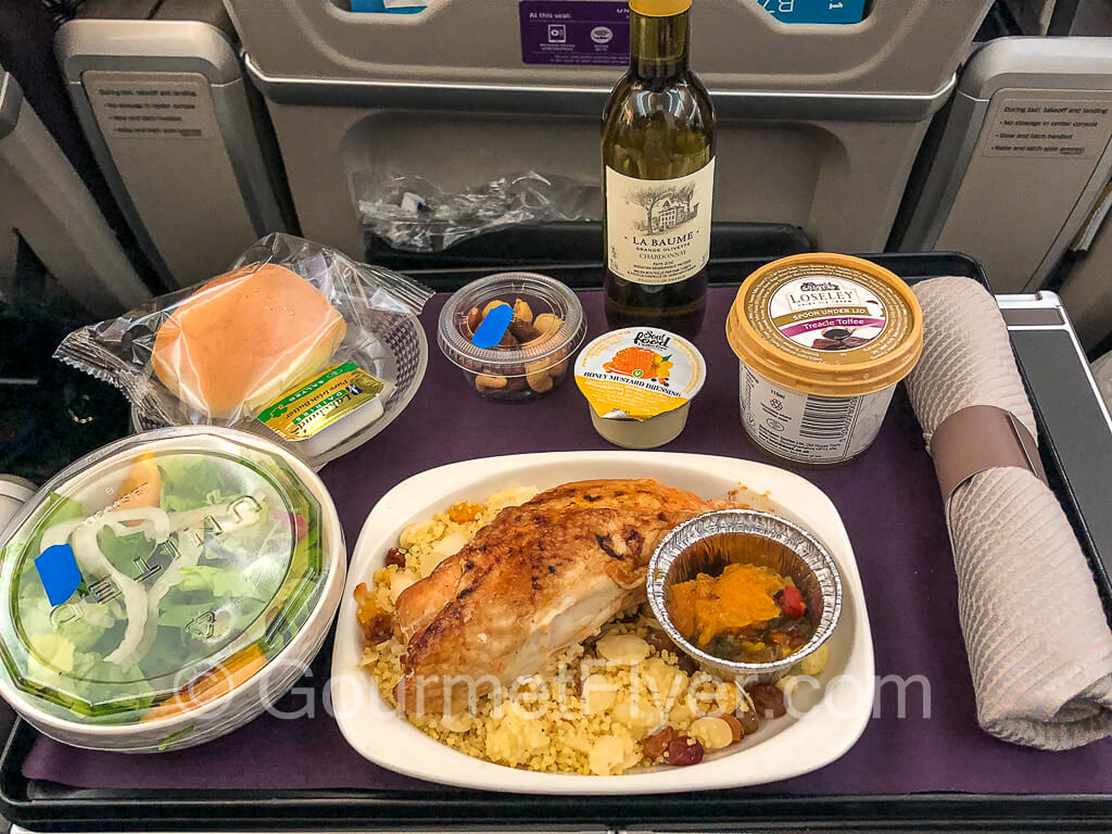 Dinner tray of United Premium PLus with chicken, salad, roll, etc.