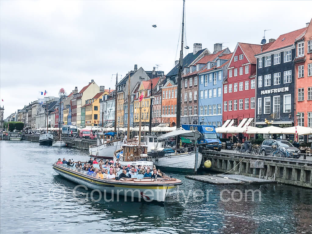 The boat of the canal tour leaving Nyhavn.