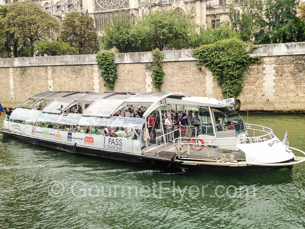 The hop-on hop-off boat full of passengers.