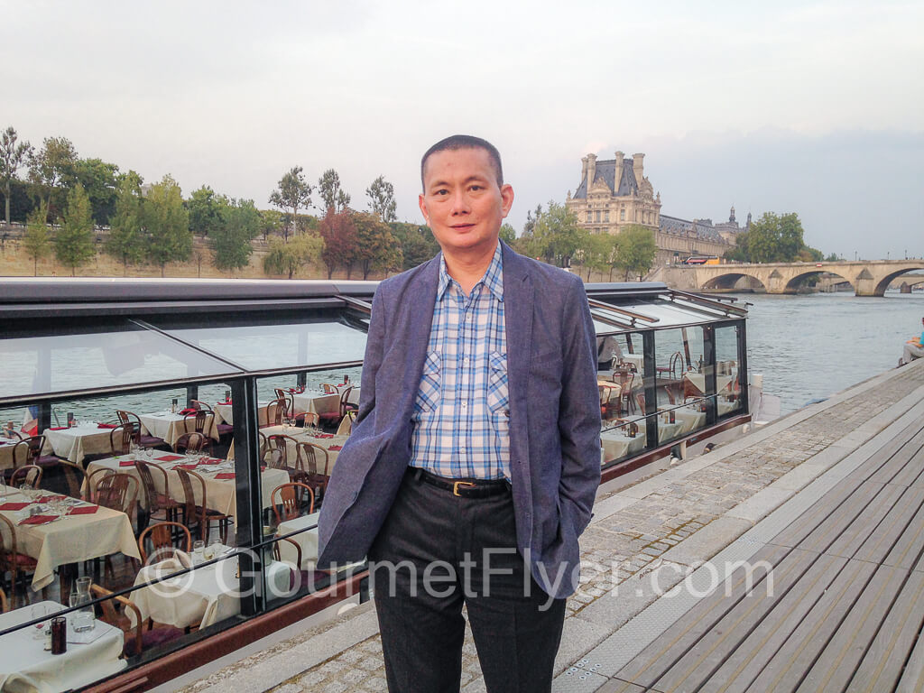 The Gourmet Flyer posing in front of the La Marina dinner cruise boat before departure.