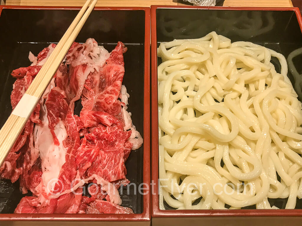 Raw sliced Kobe beef and soba.
