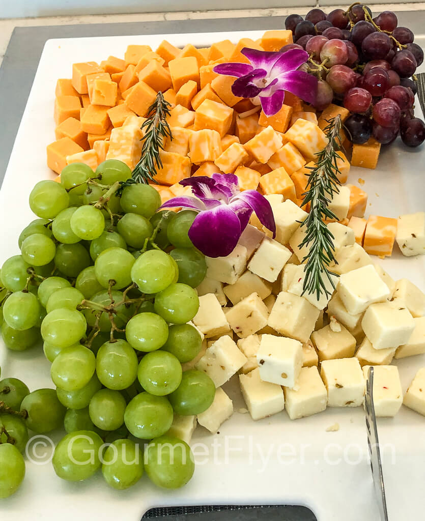 A cheese platter with grapes.