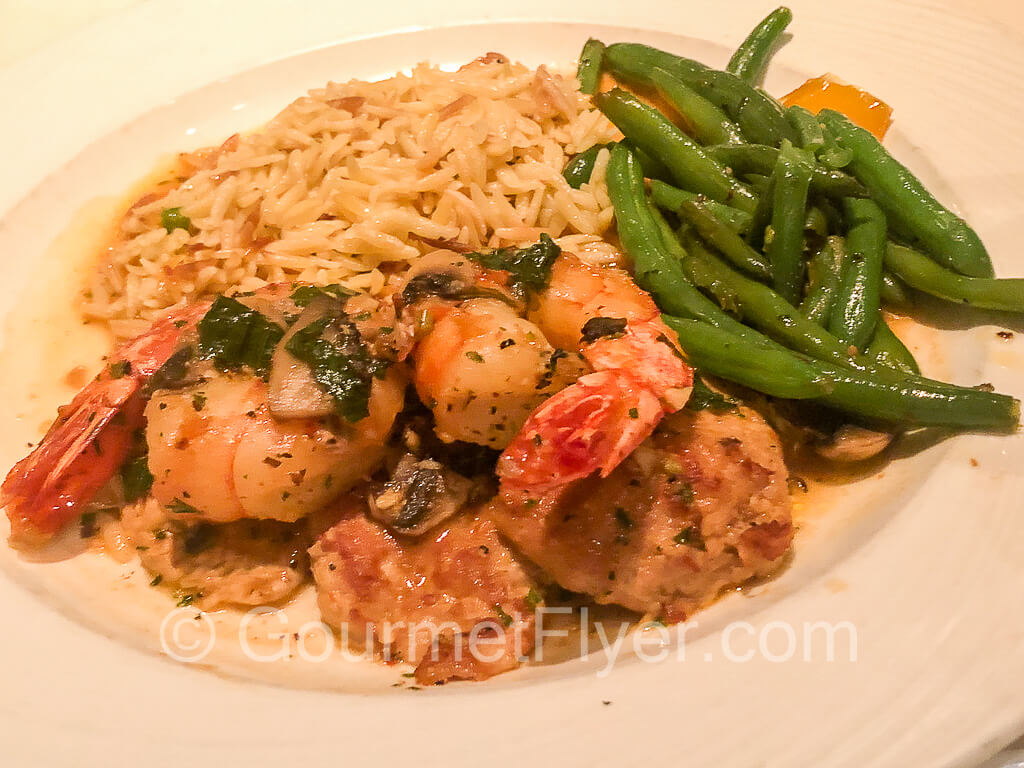 Veal scallopini served with prawns, green beans, and orzo pilaf.