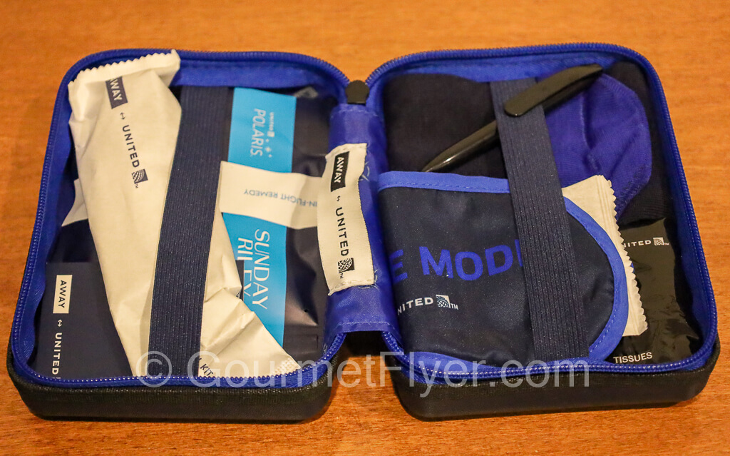 Contents of the amenities kit stored inside the plastic case is displayed.