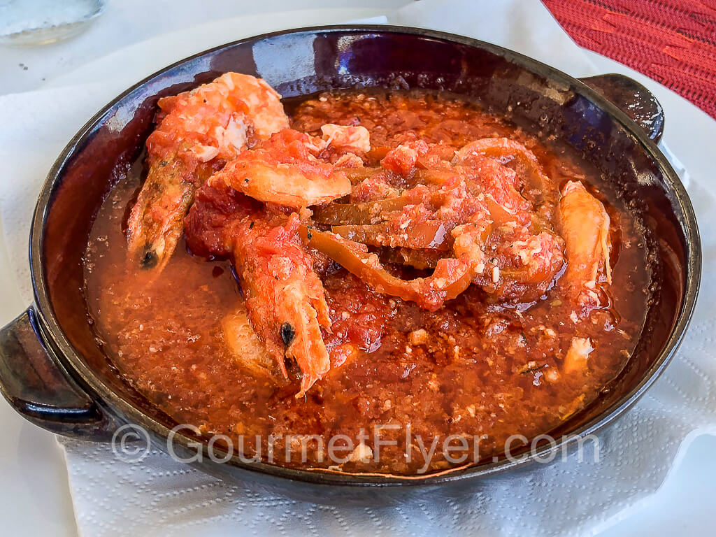 Shelled prawns in a rich tomato sauce.