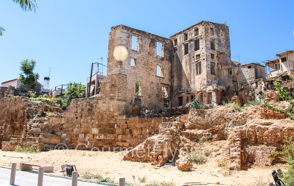 The ruins of a building has only its two walls at a right angle left. The rest of the structure has been crumbled.