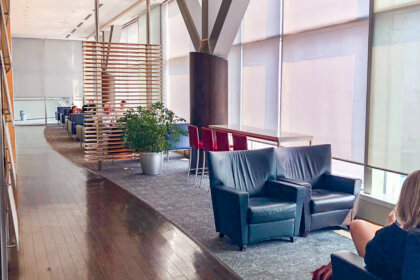 Review of Air Canada's Maple Leaf Lounge in Vancouver features several sets of lounge chairs lining tall floor to ceiling windows.