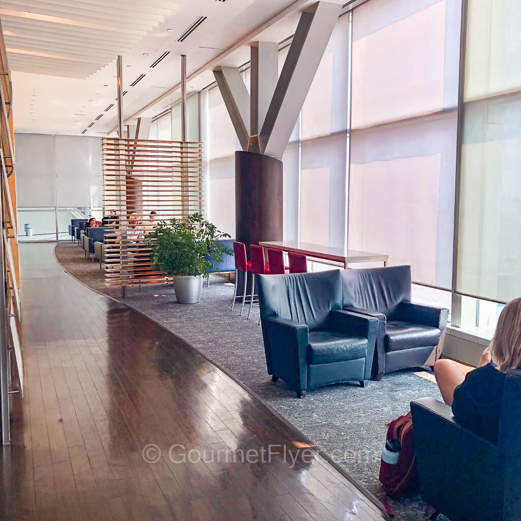 Review of Air Canada's Maple Leaf Lounge in Vancouver features several sets of lounge chairs lining tall floor to ceiling windows.
