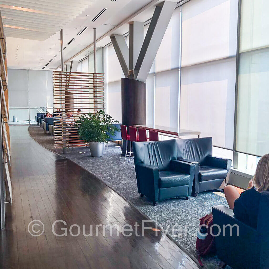 Lounge chairs line the floor-to-ceiling windows of the club.