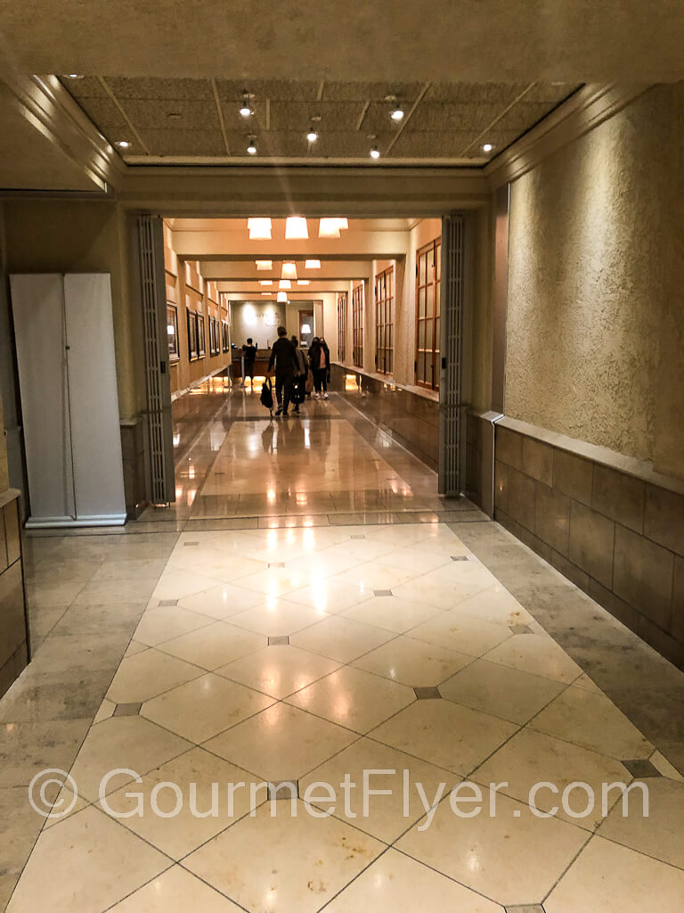A long corridor with marble floor leads to the main reception desk.