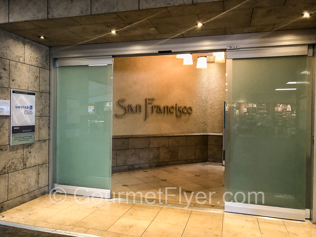 Front entrance to the United Club with the automatic glass doors opened.