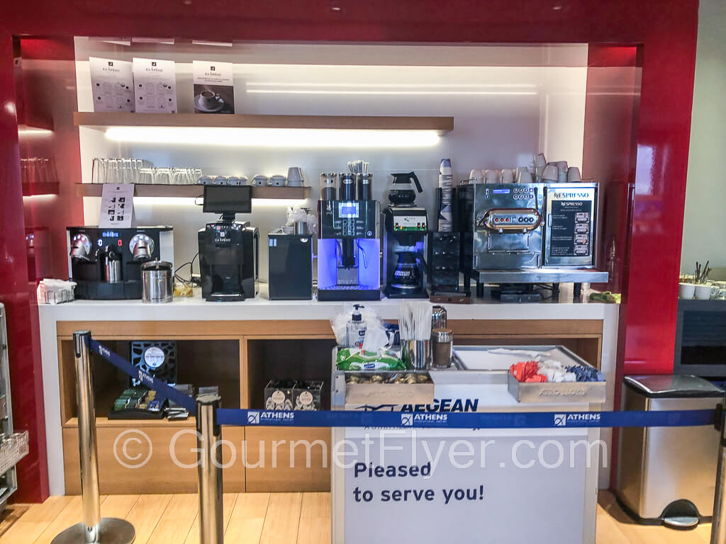 Several coffee machines are equipped on top of a counter.