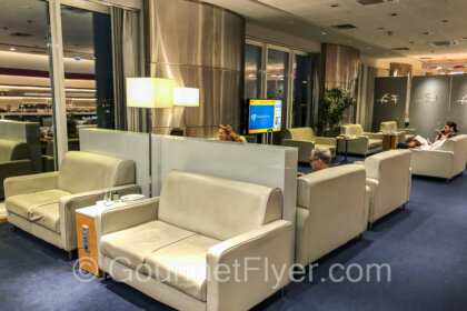 Review of Aegean Business Lounge Athens ATH displays comfy sofas in the main area.