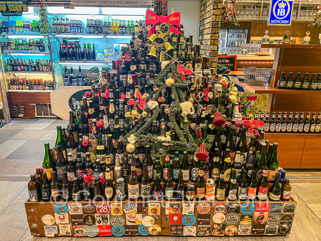 A display of many beer bottles of beers from around the world.