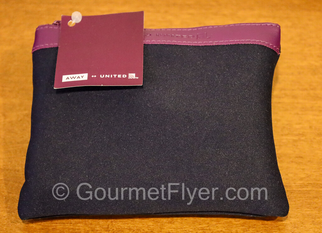 A purple color cotton fabric pouch of the amenities kit. 