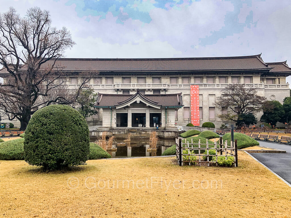 The front of the main building of the Tokyo National Museum, with a pond in the foreground.