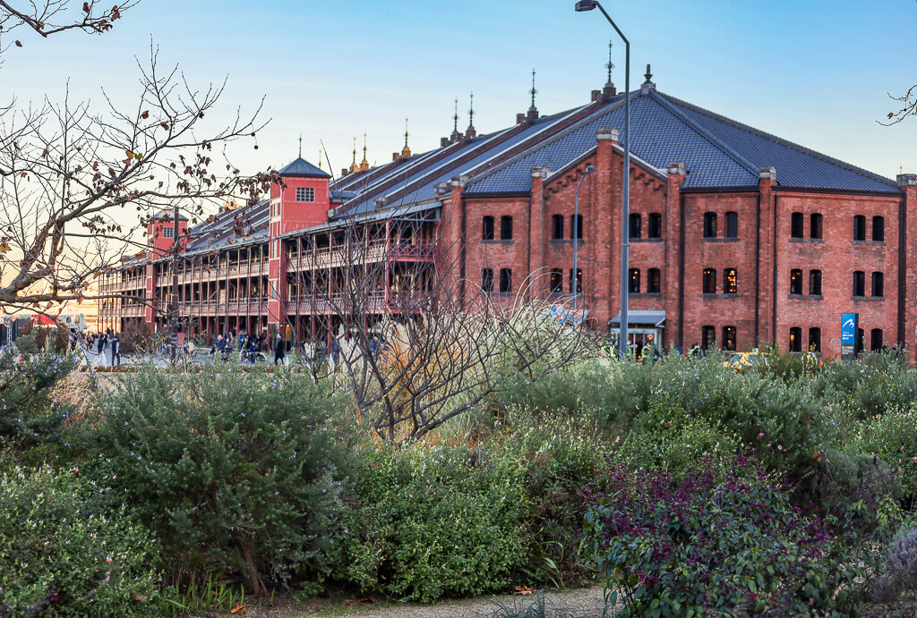 A huge red brick structure is seen from a distance -- this is known as the Red Brick Warehouse.