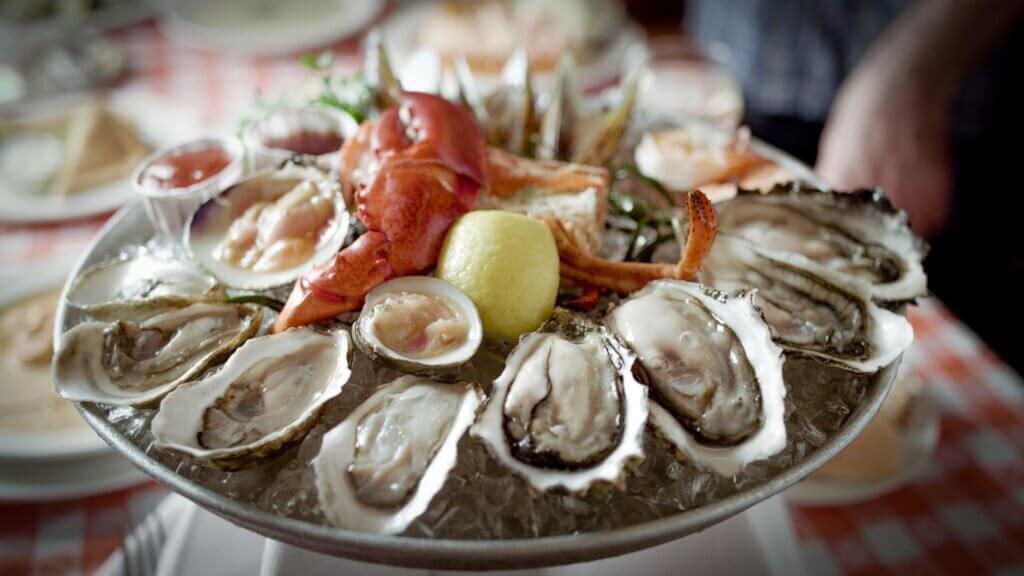 A cold seafood platter with oysters, crab claws, and clams. 