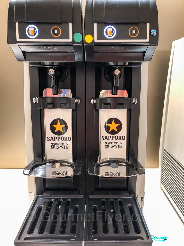 Two Sapporo beer machines are placed side by side.