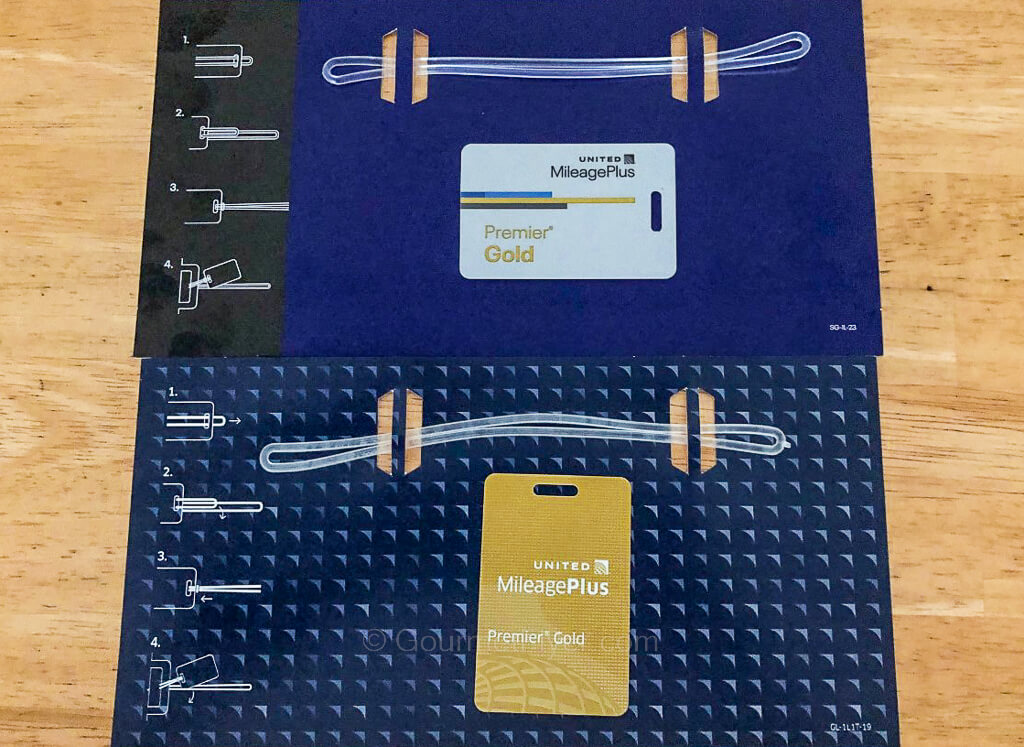 The newly designed United Gold luggage tag is placed on top and contrasted with the older design on the bottom.