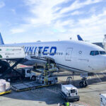 United MileagePlus Credit Card Premier Qualifying Points Promotion features a Boeing 787 aircraft parked at a gate.