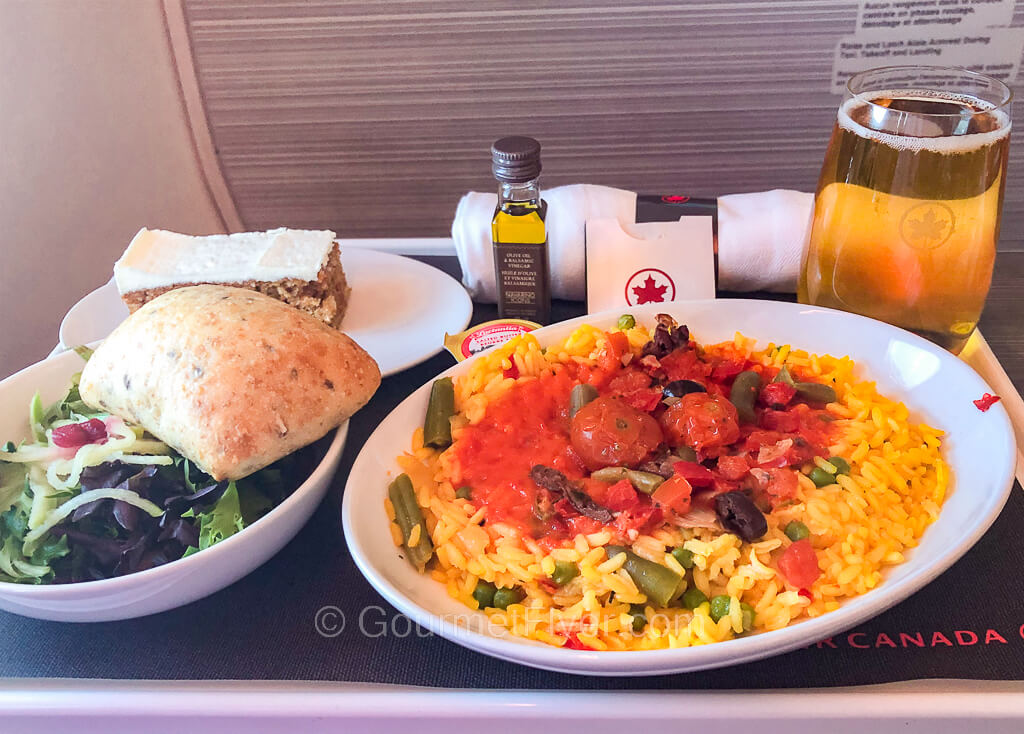 Review of my Air Canada Business Class service features a dinner tray with paella, salad, and dessert.