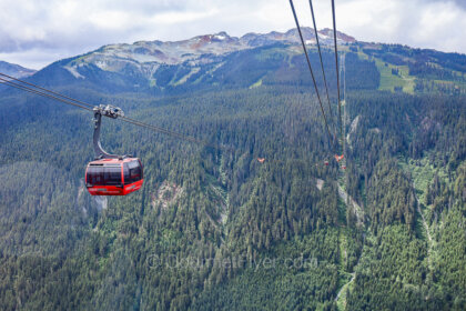 The guide to a day trip to Whistler features an iconic red Peak 2 Peak gondola traveling between the Blackcomb and Whistler Mountains.