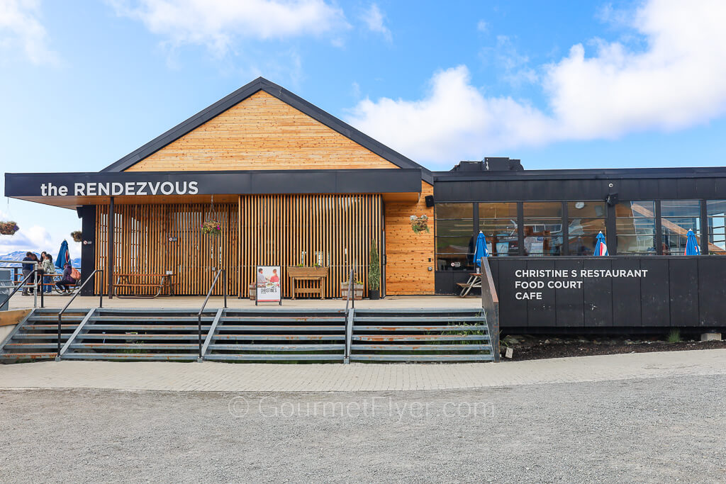 A stairway leads to a wooden building with the sign Rendezvous on the top. 