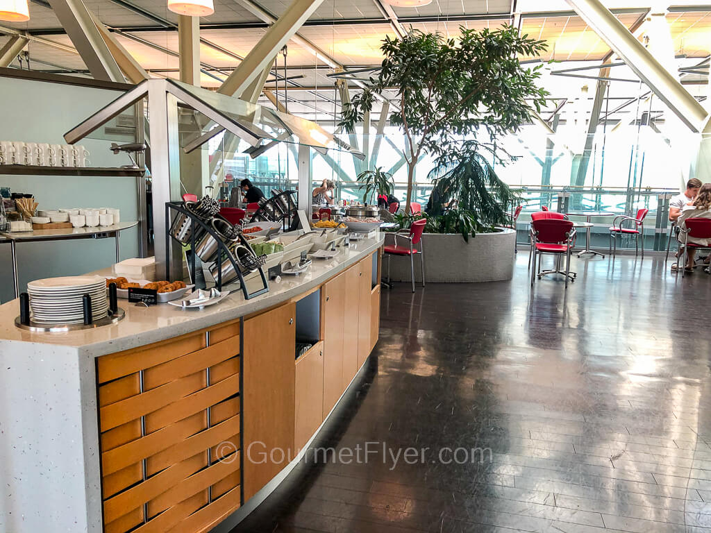 The buffet counter is located next to a seating area with tall floor to ceiling windows.