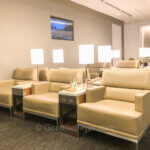 The United Club at Seattle Tacoma International Airport features wide and comfortable lounge chairs separated by coffee tables.