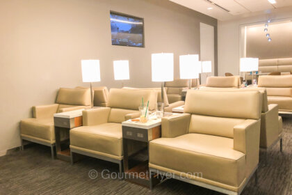 The United Club at Seattle Tacoma International Airport features wide and comfortable lounge chairs separated by coffee tables.