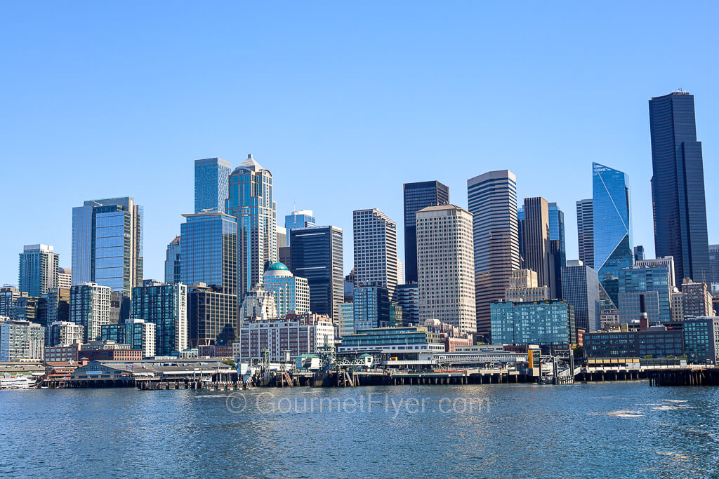 A panoramic view of Seattle's waterfront, the piers, and the skyline of its skyscrapers.