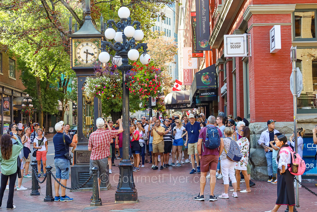 A crowd gathers around the steam clock with phones and cameras in hand, right at 3:30pm.