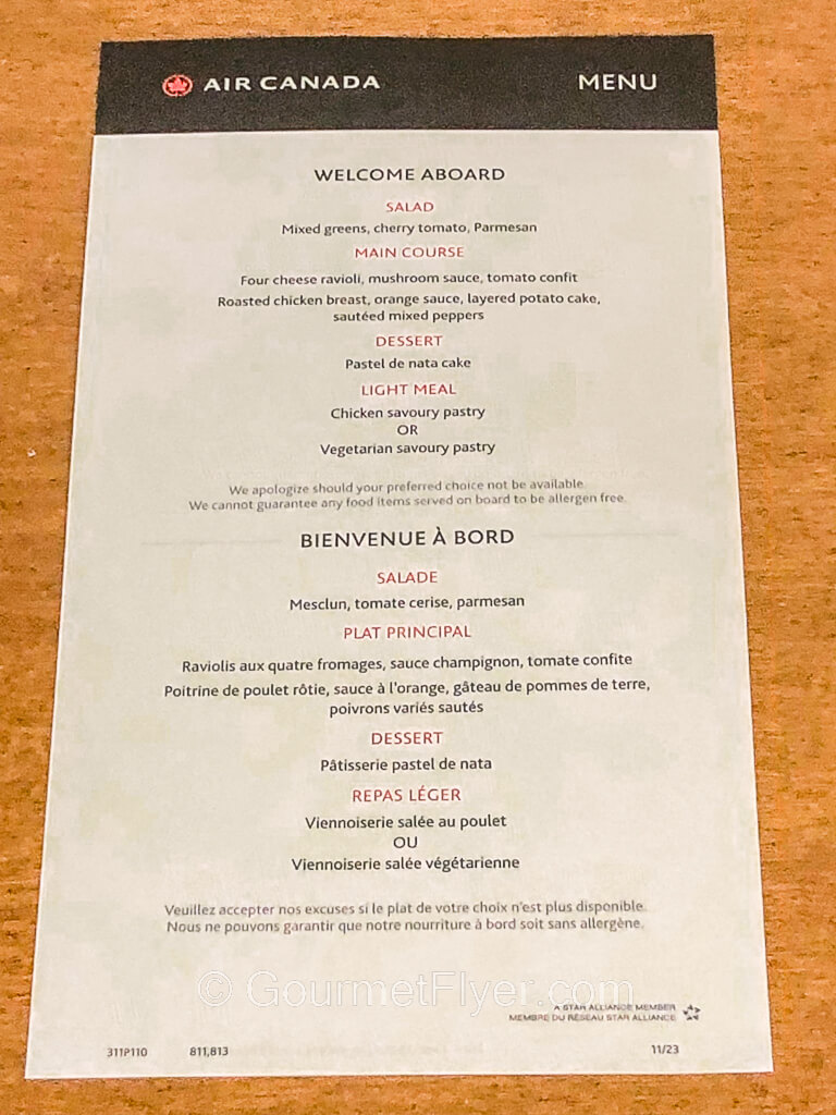 A menu with Air Canada's logo on top and contains descriptions of salad, main course, dessert, and light meal.
