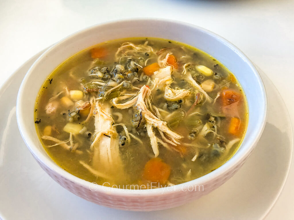 A vegetable-based soup on the menu is loaded with chicken meat and diced carrots.