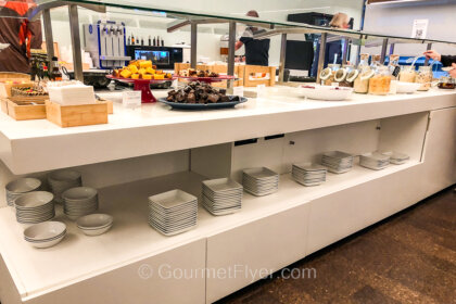 Review of TAP Air Portugal Premium Lounge in Lisbon features an extensive buffet counter with a wide variety of food offerings.
