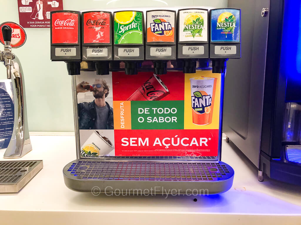 A soda machines with buttons that serve Coke, Sprite, Fanta, and Nestea.
