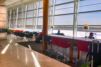 Review of Air Canada's Maple Leaf Lounge in Montreal features a spacious and comfortable seating area by the window.