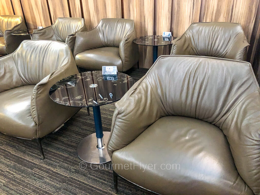 Two rows of large sofas have small coffee tables placed between them.