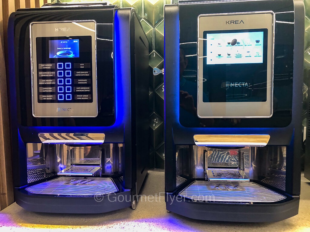 Two espresso machines are placed side by side on a counter.