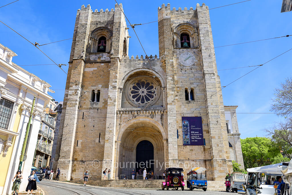 The facade of a tall and imposing cathedral with twin bell towers.