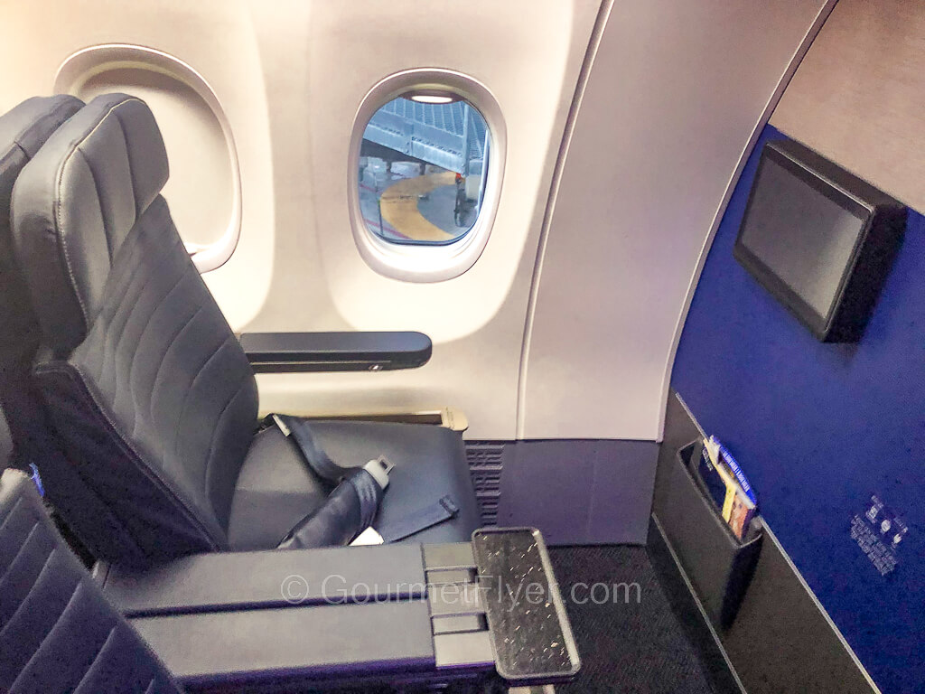 A first-class window seat with spacious legroom and an extra wide armrest.