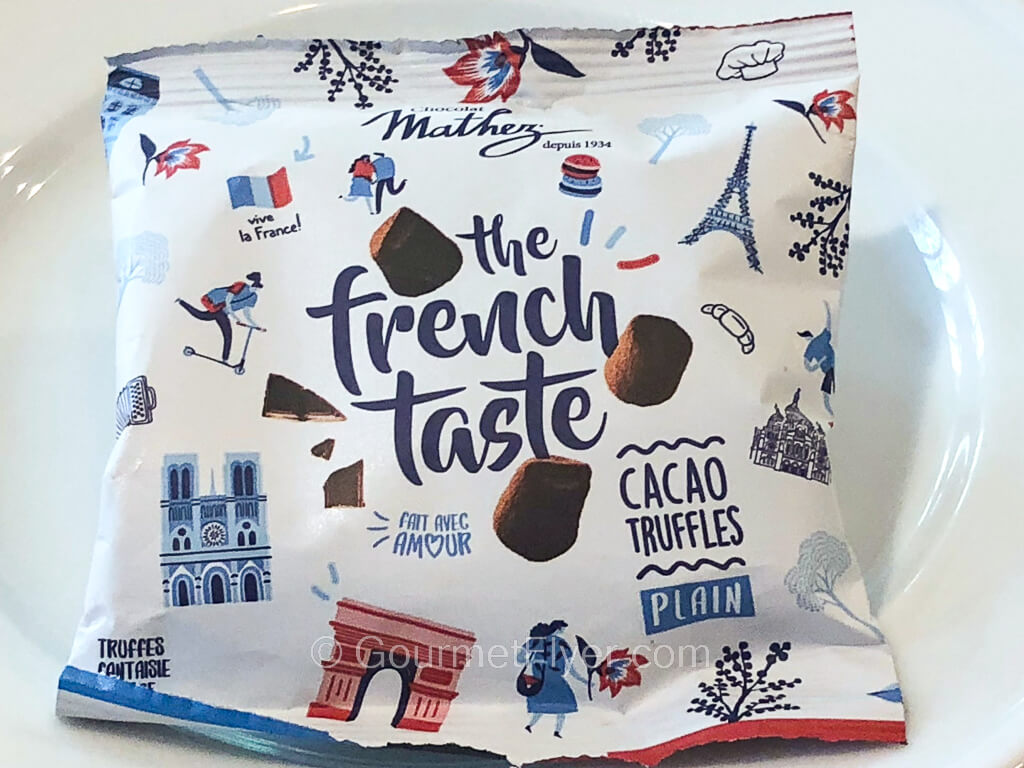 A white package with French wordings and graphics is said to contain chocolate truffles.
