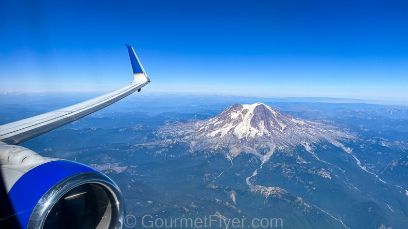 An invitation to guest posts features a mountain with an icy top as viewed from a plane, with the wingtips visible.