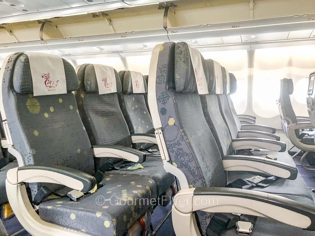 Two rows of the middle section of an aircraft have four seats across.