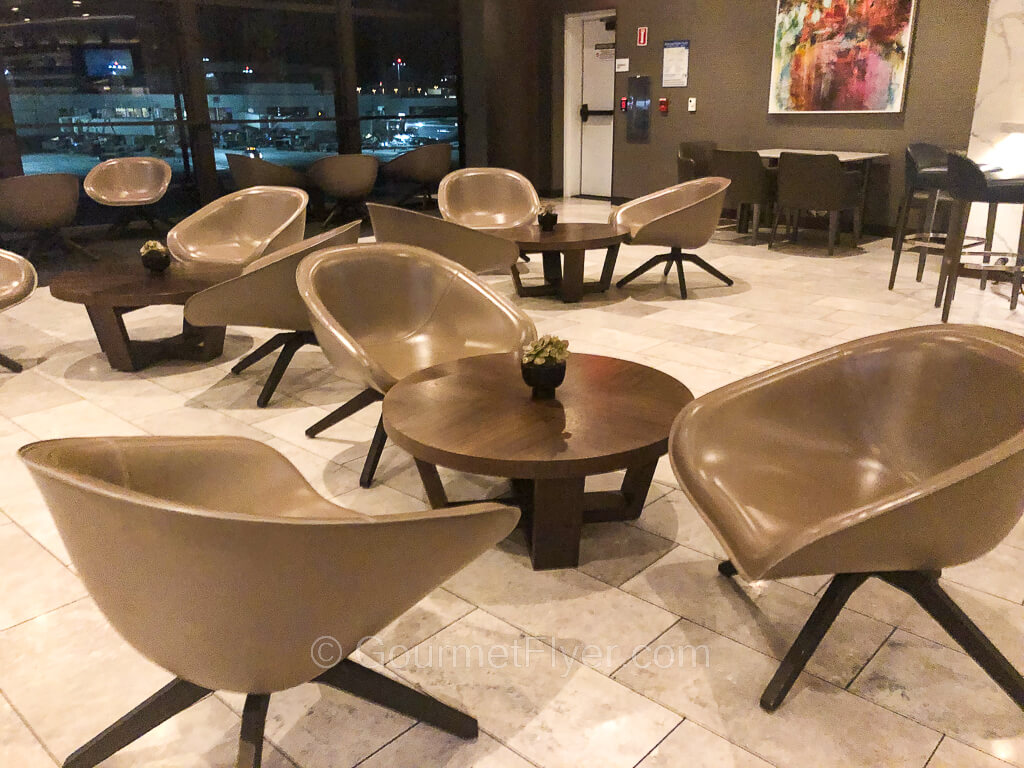 Several sets of chairs accompanied by coffee tables are placed in various areas on the floor.