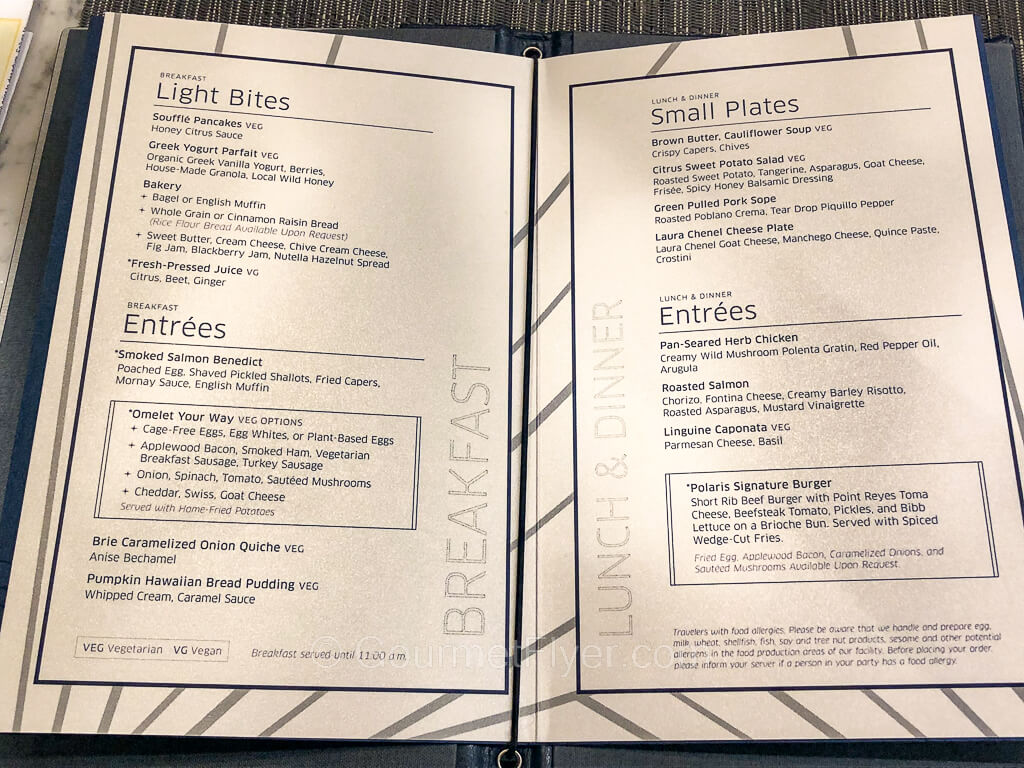 A hardcover menu displays breakfast choices on the left and dinner options on the right.